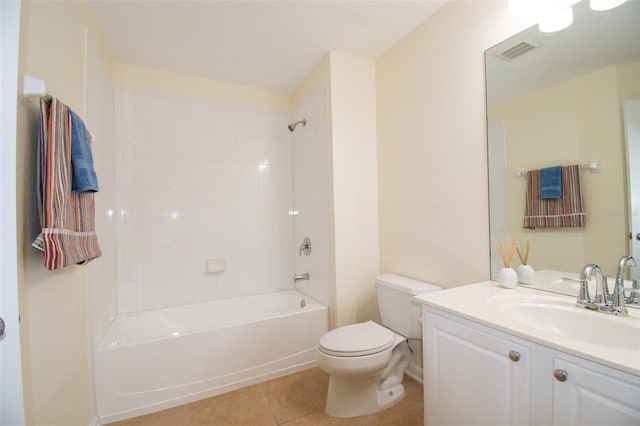 full bathroom featuring toilet, vanity, tile patterned flooring, and tiled shower / bath