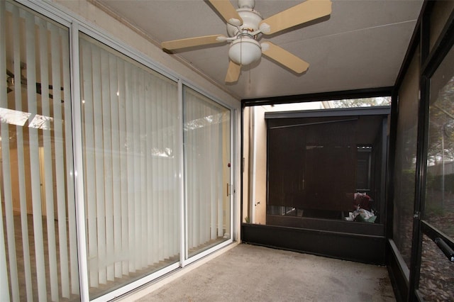 unfurnished sunroom with ceiling fan