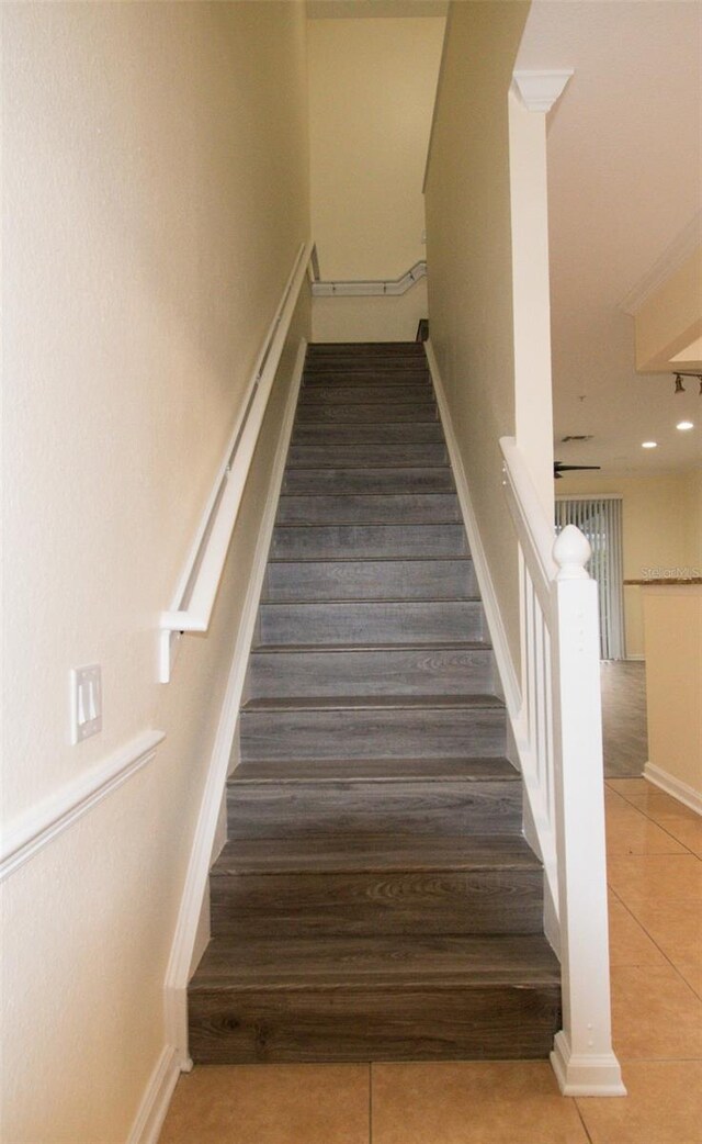 6855 Sperone St, Orlando, FL 32819 - staircase featuring tile patterned floors and baseboards