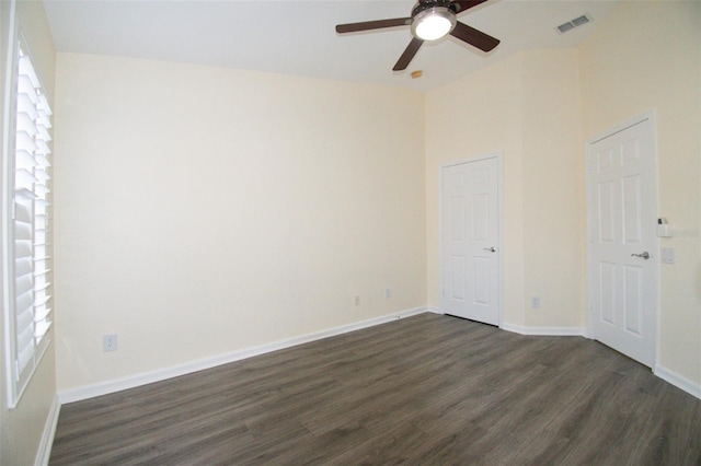 6855 Sperone St, Orlando, FL 32819 - unfurnished bedroom with dark wood-type flooring, lofted ceiling, and ceiling fan
