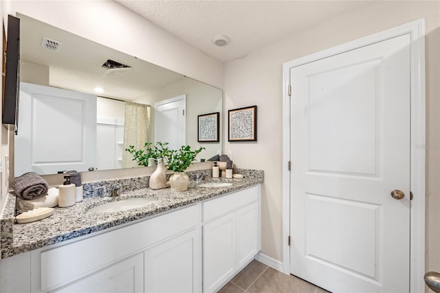 bathroom with tile patterned floors and vanity