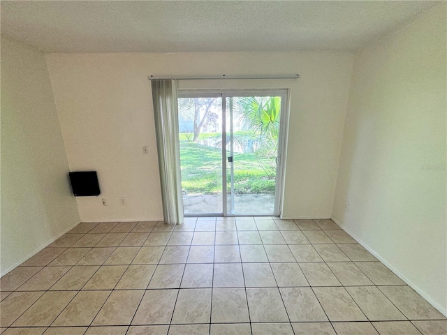 unfurnished room featuring light tile patterned floors