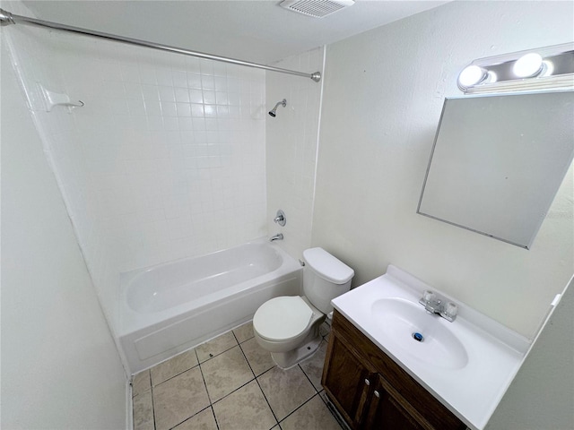 full bathroom with tile patterned flooring, vanity, tiled shower / bath combo, and toilet