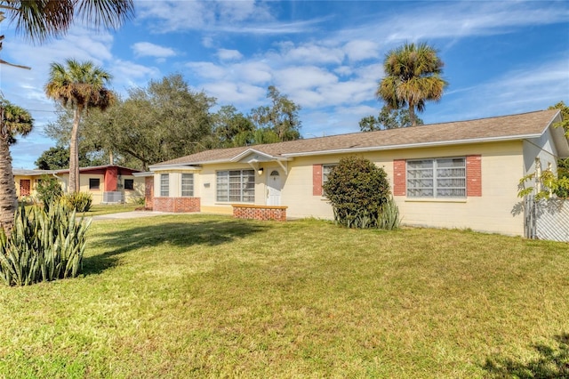 ranch-style house with a front lawn