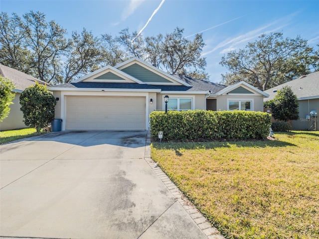 view of front of home with a garage and a front lawn