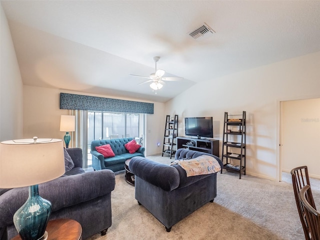 carpeted living room with ceiling fan and lofted ceiling