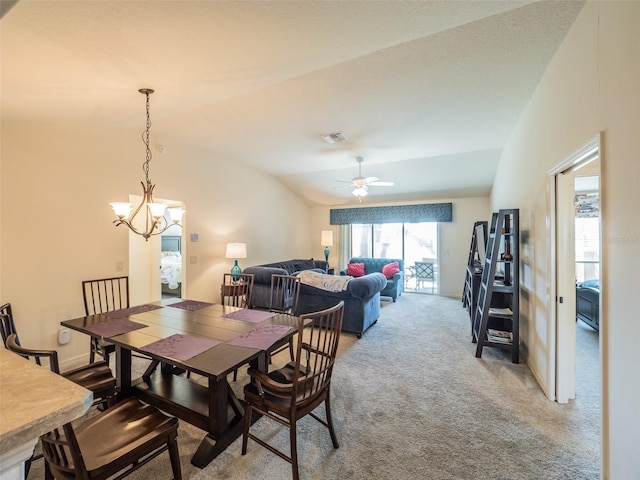 dining area featuring ceiling fan, carpet floors, and vaulted ceiling