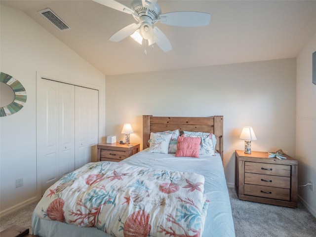 carpeted bedroom with vaulted ceiling, a closet, and ceiling fan