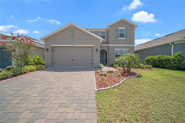 front of property with a garage and a front lawn