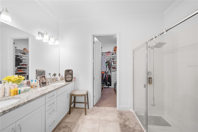 bathroom featuring crown molding, vanity, an enclosed shower, and tile patterned flooring