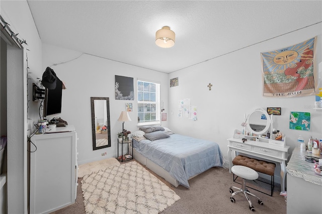 carpeted bedroom featuring a textured ceiling