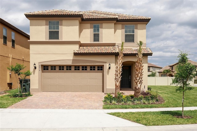 mediterranean / spanish-style home featuring a garage and a front yard