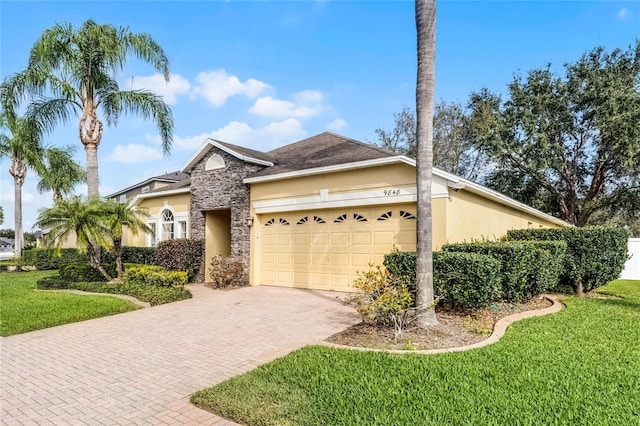 view of front of house with a garage and a front lawn