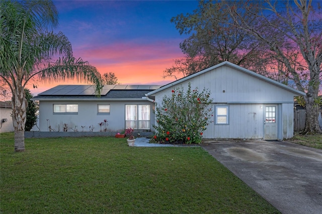 single story home with a lawn