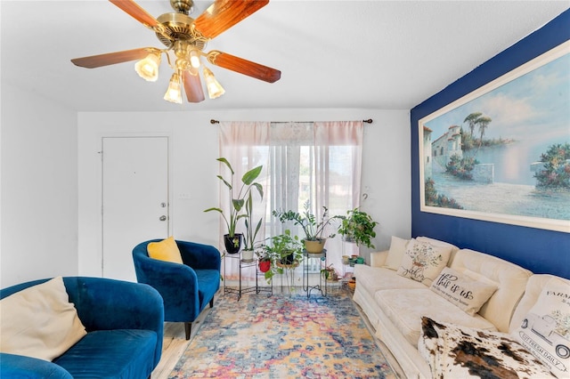 living room featuring ceiling fan and light hardwood / wood-style flooring