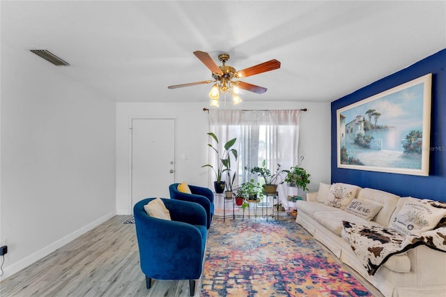 living room with light hardwood / wood-style floors and ceiling fan