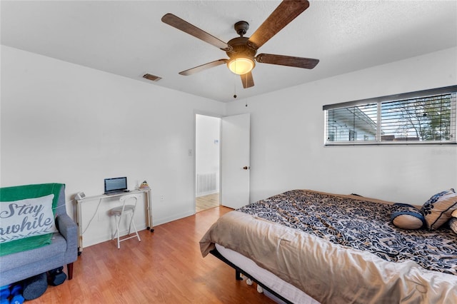 bedroom with ceiling fan and light hardwood / wood-style flooring