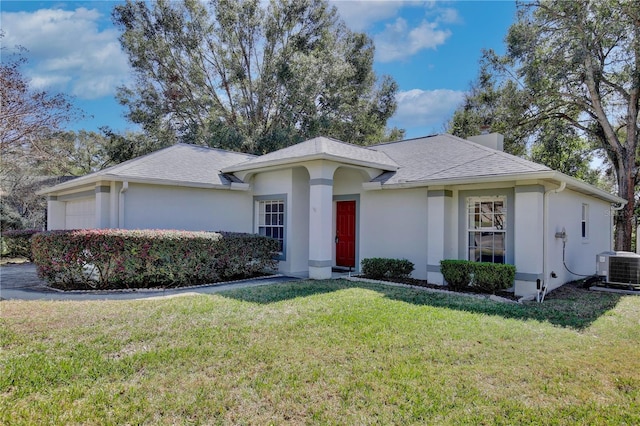 ranch-style home with a garage, central AC, and a front yard