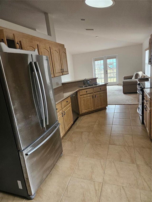 kitchen featuring a peninsula, a sink, stainless steel appliances, marble finish floor, and open floor plan