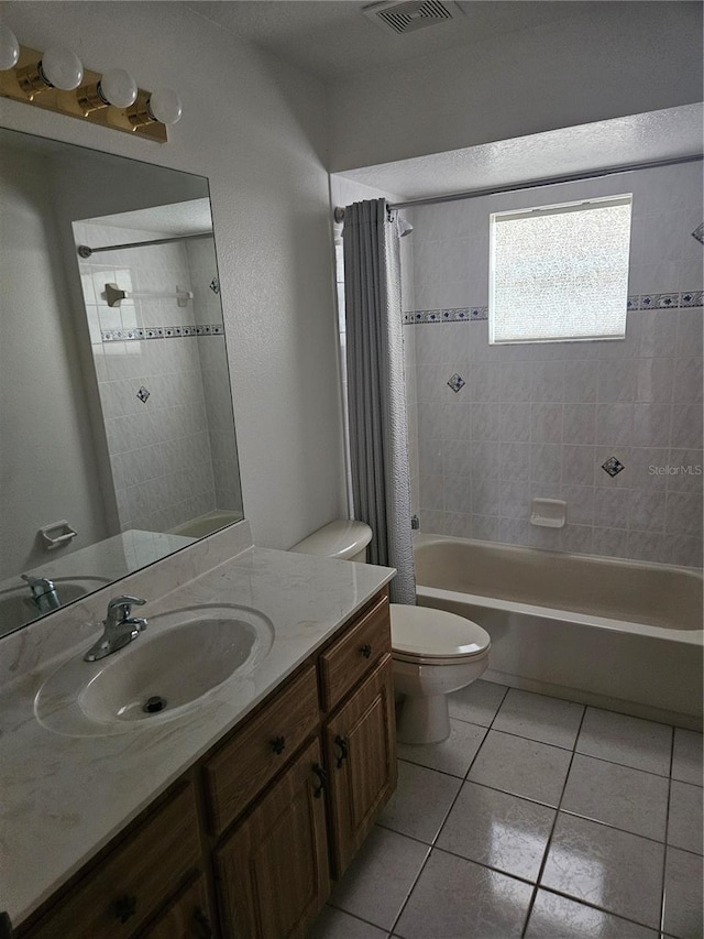 bathroom featuring vanity, visible vents, shower / bath combo, tile patterned flooring, and toilet