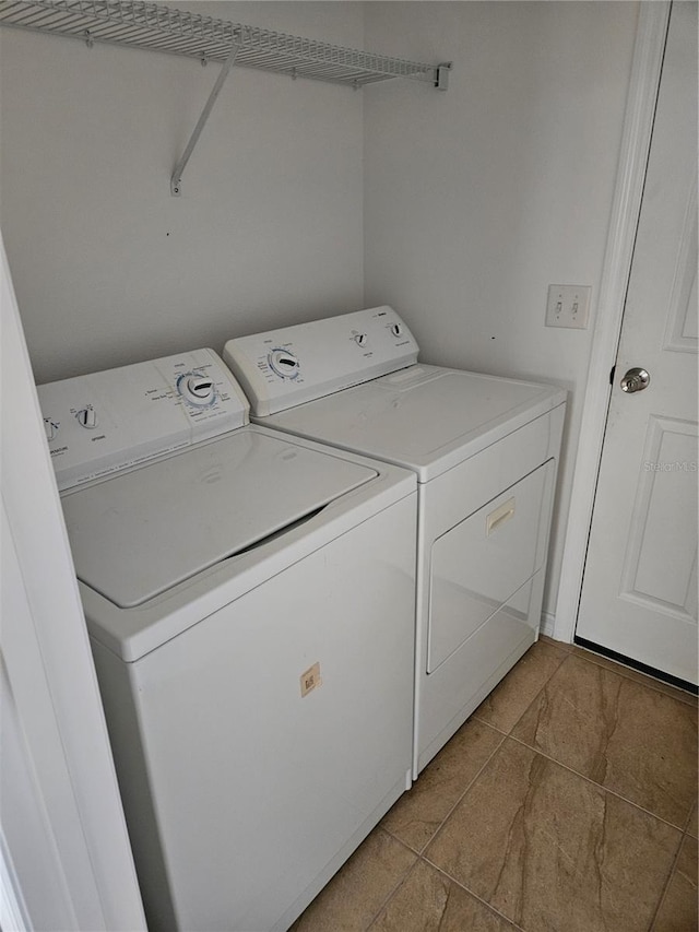 clothes washing area with independent washer and dryer and laundry area