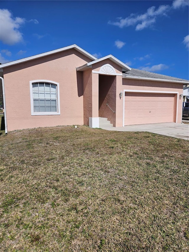 single story home featuring stucco siding, driveway, an attached garage, and a front lawn