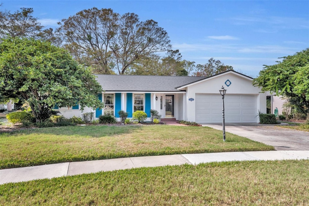 ranch-style house with a garage and a front yard