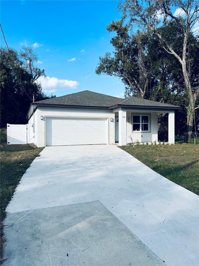 ranch-style home featuring concrete driveway, stucco siding, roof with shingles, an attached garage, and a front yard