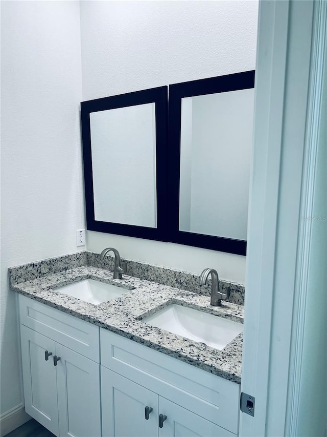 bathroom featuring double vanity and a sink