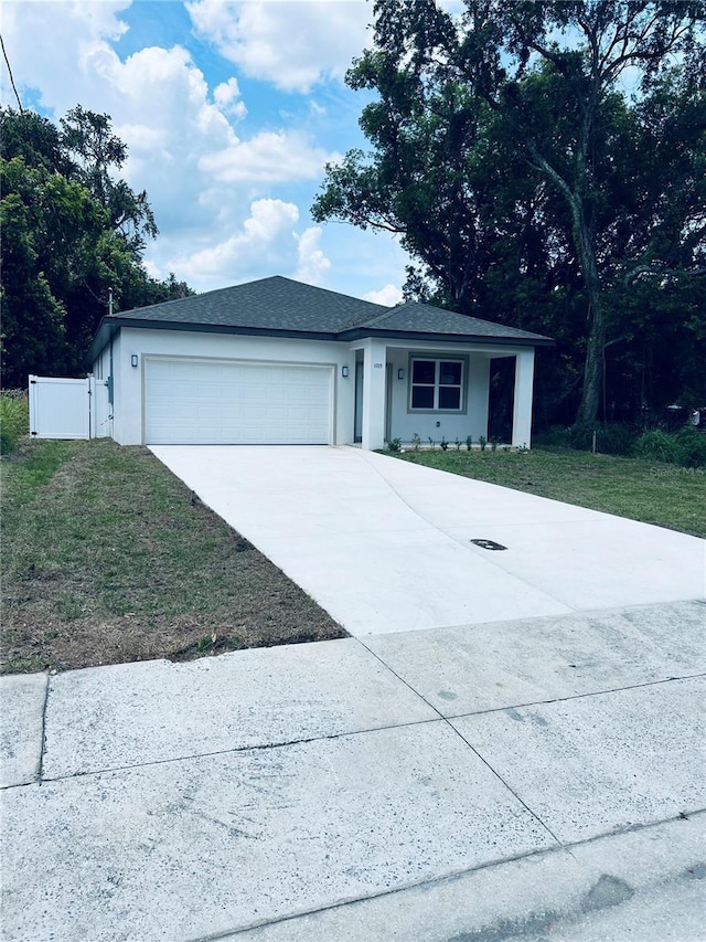 1015 25th St, Orlando, FL 32805 - ranch-style home with an attached garage, driveway, and stucco siding
