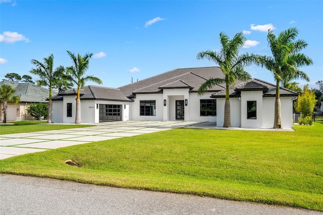 view of front of home with a garage and a front yard