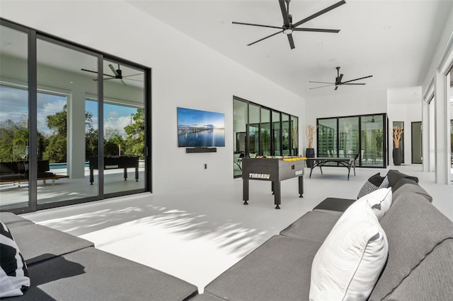 interior space featuring ceiling fan and concrete floors