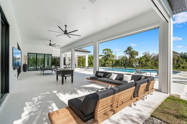 view of patio with an outdoor living space and ceiling fan