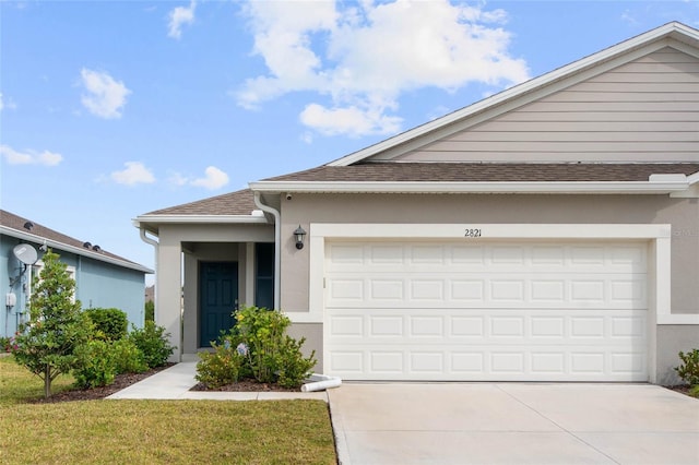 ranch-style house featuring driveway, a garage, a shingled roof, a front lawn, and stucco siding