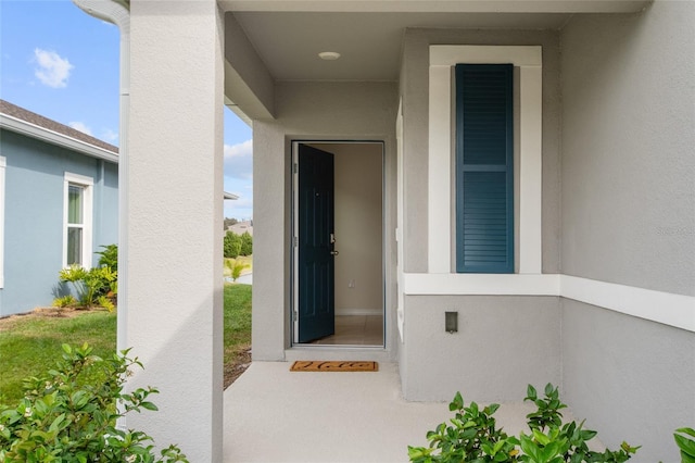 doorway to property with stucco siding