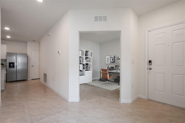 foyer entrance featuring light tile patterned floors, visible vents, and baseboards