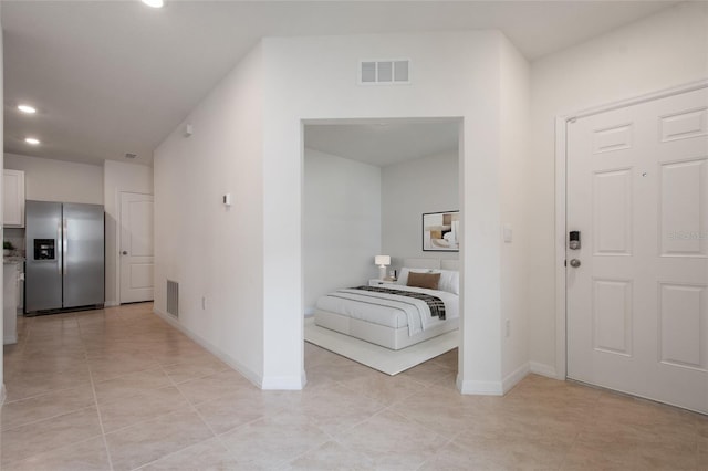 hall featuring light tile patterned floors, baseboards, visible vents, and recessed lighting