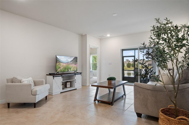 living room with recessed lighting, baseboards, and light tile patterned flooring