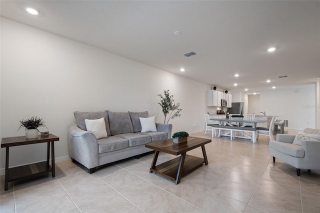 living room with light tile patterned flooring, baseboards, visible vents, and recessed lighting