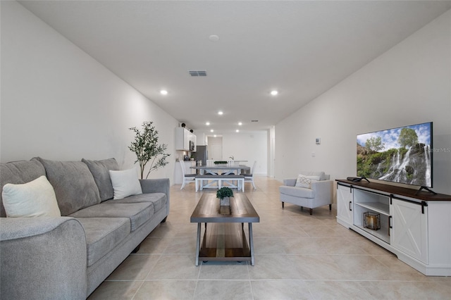 living area featuring recessed lighting, visible vents, and light tile patterned floors