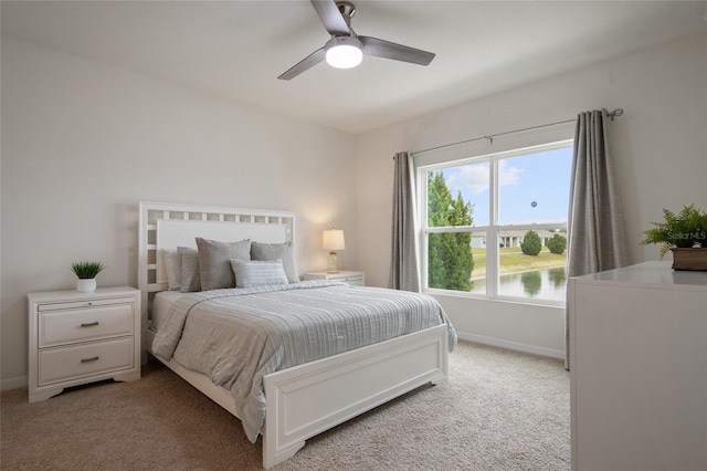 bedroom with light carpet, ceiling fan, and baseboards