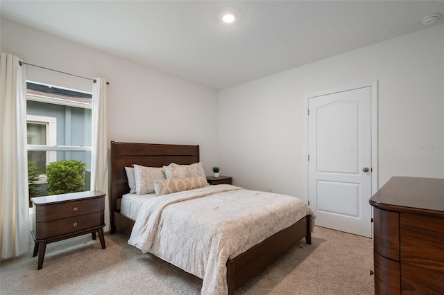 bedroom with light colored carpet