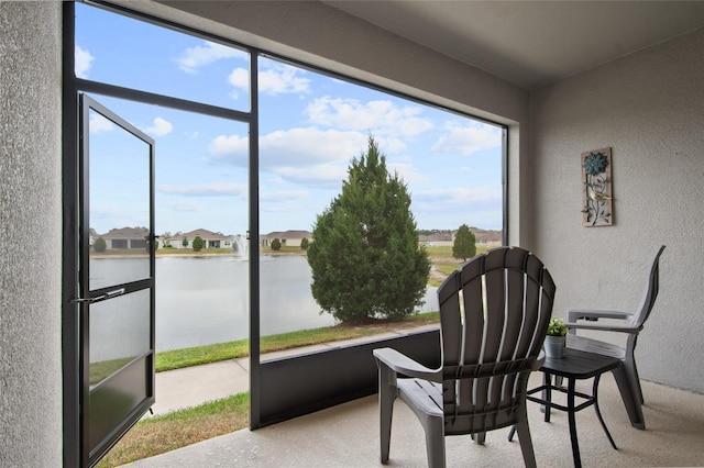 sunroom / solarium with a water view