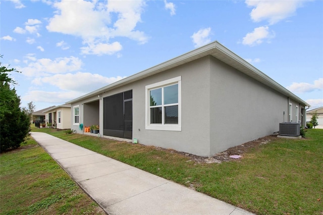 view of property exterior featuring cooling unit, a yard, and stucco siding