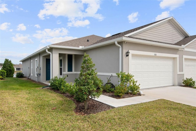 view of front of home featuring a shingled roof, concrete driveway, an attached garage, a front yard, and stucco siding