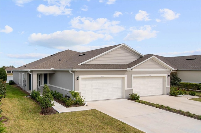 view of front of house with stucco siding, a shingled roof, concrete driveway, a front yard, and a garage