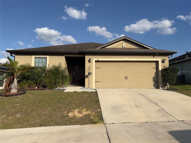 single story home with a garage, a front yard, and cooling unit