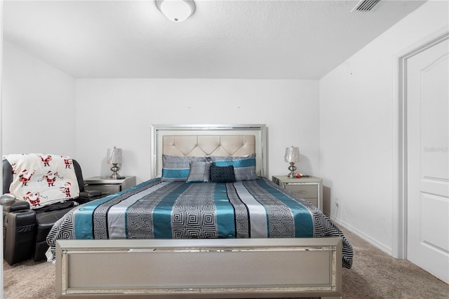 carpeted bedroom with a textured ceiling