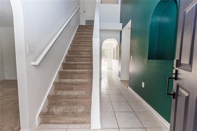 stairway with tile patterned flooring