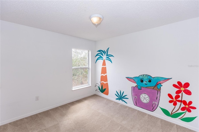 playroom featuring carpet floors and a textured ceiling